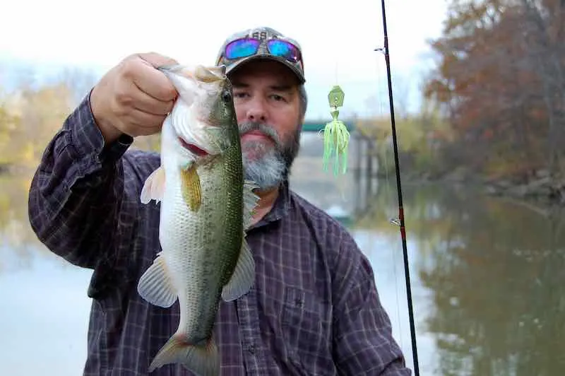 fisherman holding a large mouth bass closeup