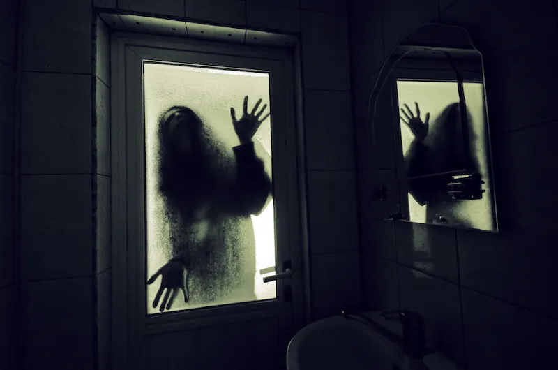 Horror woman in window halloween haunted house