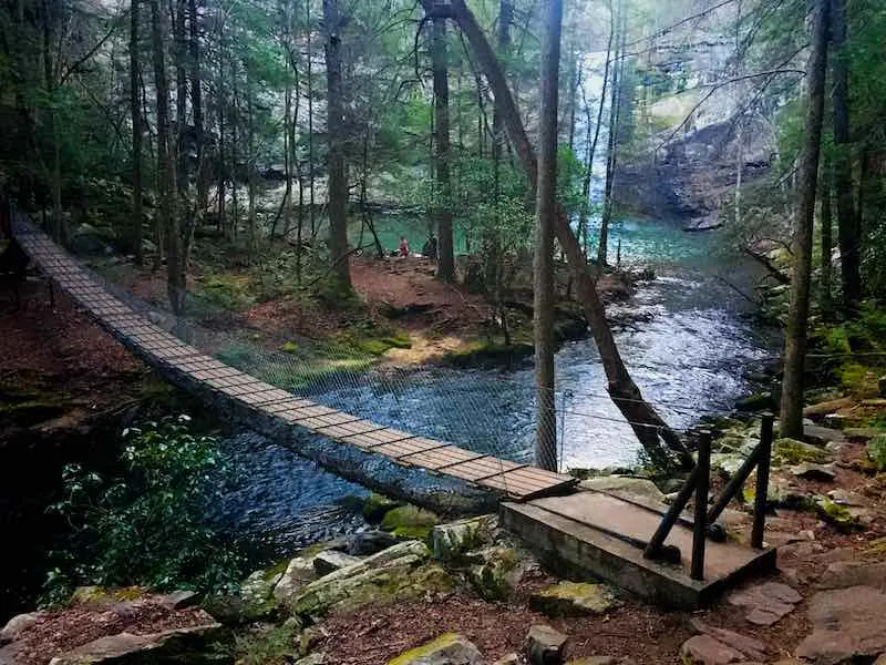 suspension footbridge and the waterfall at Foster Falls along the Fiery Gizzard Trail in South Cumberland State Park in Tennessee.