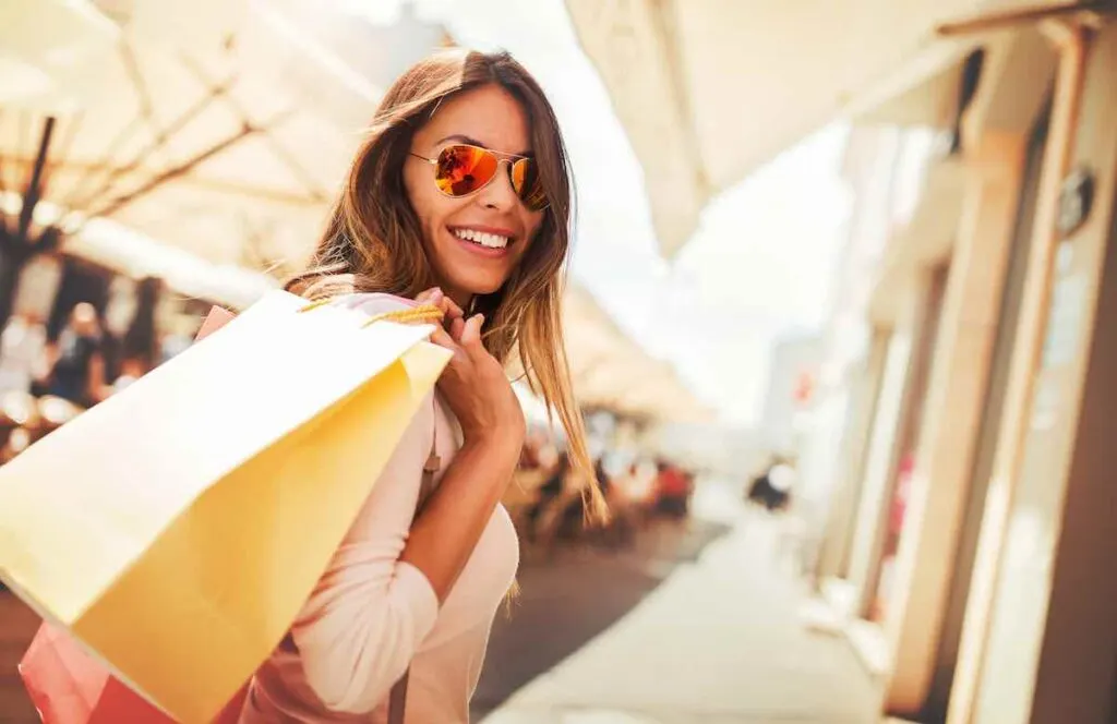 Happy woman with shopping bags enjoying in shopping
