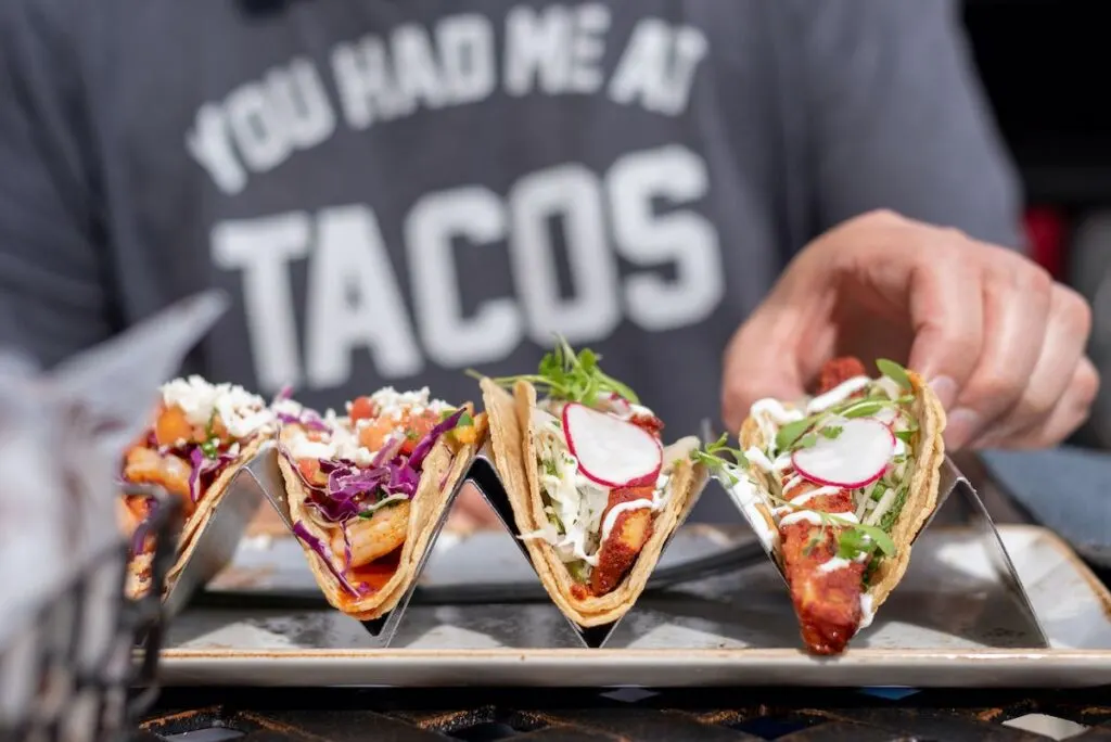 man eating tacos outside in summer