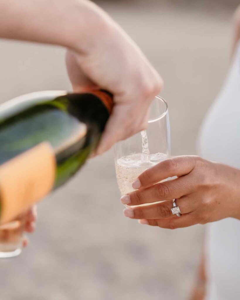 OYSTER BAY, NEW YORK Couple Celebrating their Engagement with a Champagne Toast