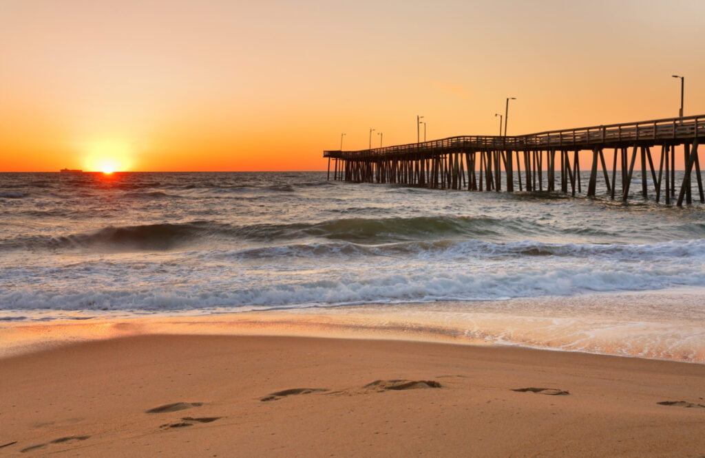 A sunrise on Virginia beach with the pier.