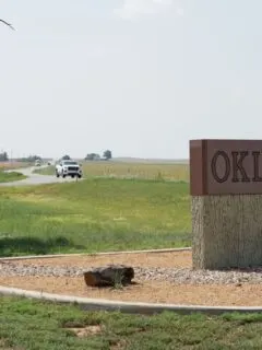 A sign that says Oklahoma on it. In the state you can find some of the best camping in Oklahoma.
