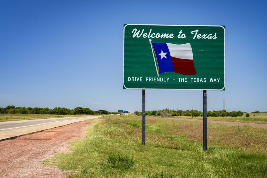 A sign that says "Welcome to Texas." Here you can probably find the best aquariums in Texas.