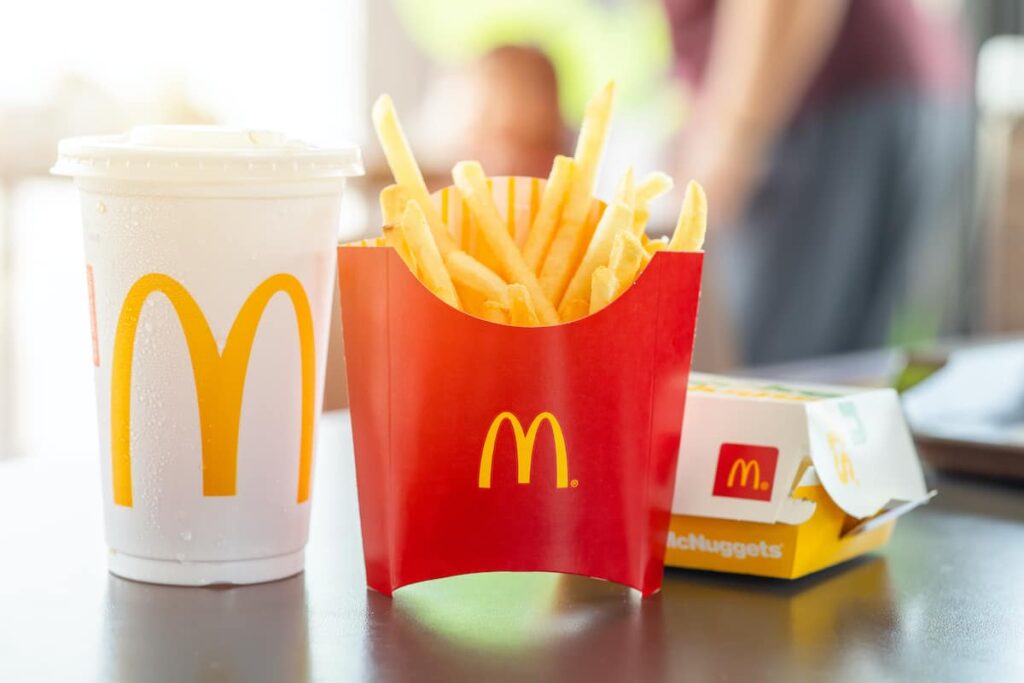 A classic McDonald's fast food meal with chicken McNuggets, fries, and a soft drink. 