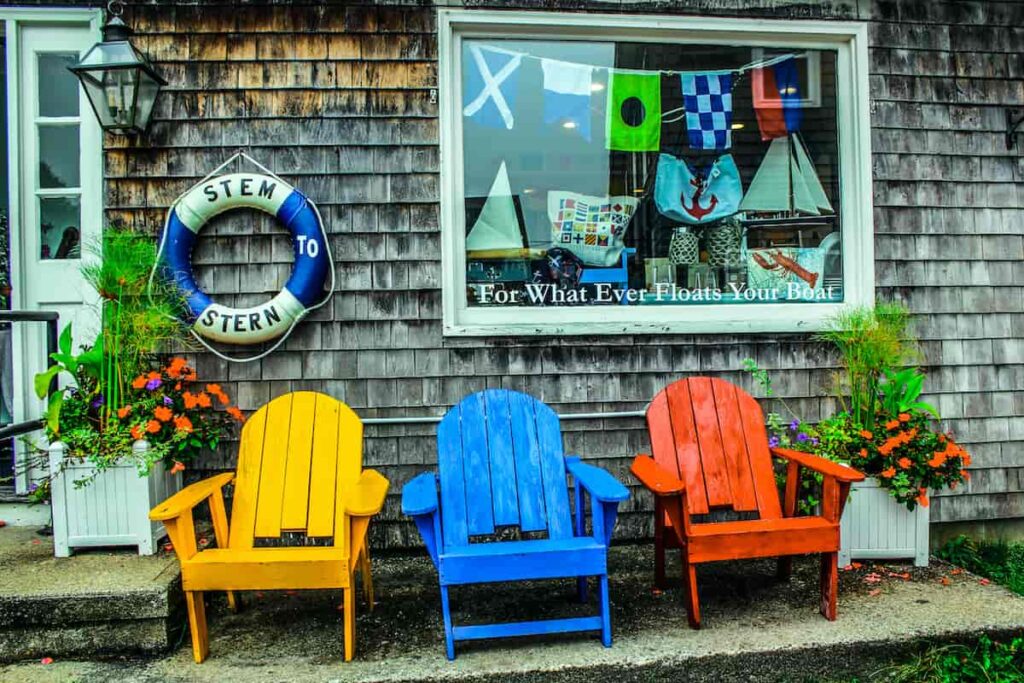 Colorful Adirondack chairs outside a shop in Kennebunkport, ME. American small towns.