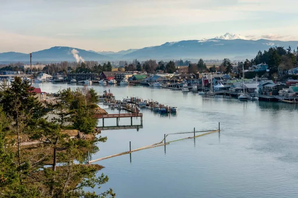 Aerial view of La Conner, WA with mountains in the background.