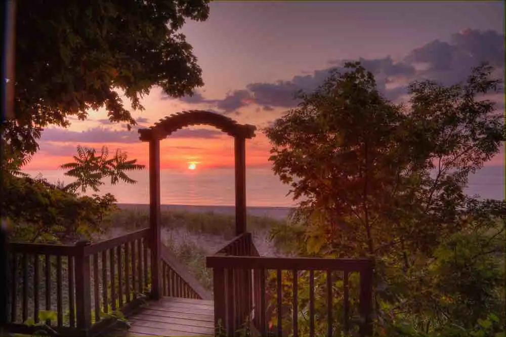 wooden arch on lake michigan beach